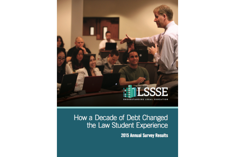 A book cover for "How a Decade of Debt Changed the Law Student Experience: 2015 Annual Survey Results." The top of the cover is a photo of a diverse group of law students sitting at desks in a lecture hall. A professor is standing at the front of the room, gesturing with his hands and speaking to the students. The bottom of the cover is a blue-gray background with the title in white font. A small, green and white LSSSE logo is at the bottom.